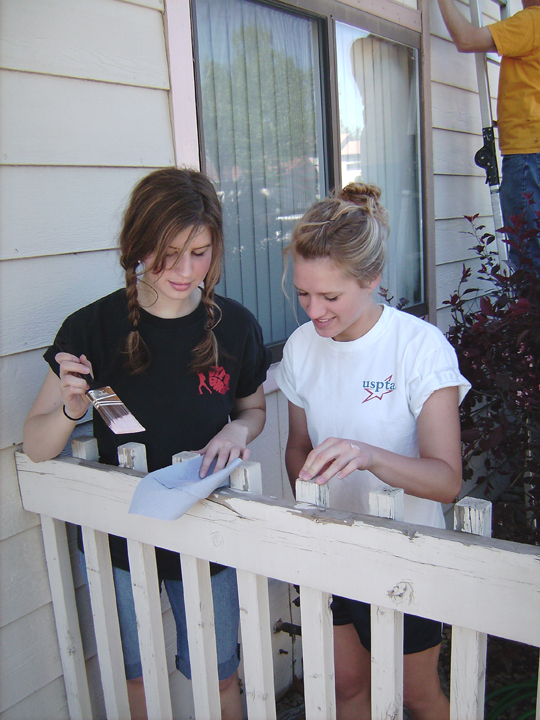 Catherine Compton (on the right) and Rachelle Dietz paint a balcony railing for the Boulder Colorado Stake’s Colorado Cares Day project on May 12, 2007.